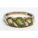 9ct Yellow gold three stone peridot ring. Weight 3g, Size P.