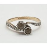 9ct Gold and platinum ring having two pale aqua stones to top in crossover style. Preserved in