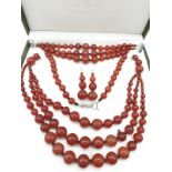 A three rows of round polished carnelian, necklace, bracelet and earrings set in a presentation box.