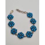 A silver and turquoise bracelet in floral form. 19.6g, 16cm.