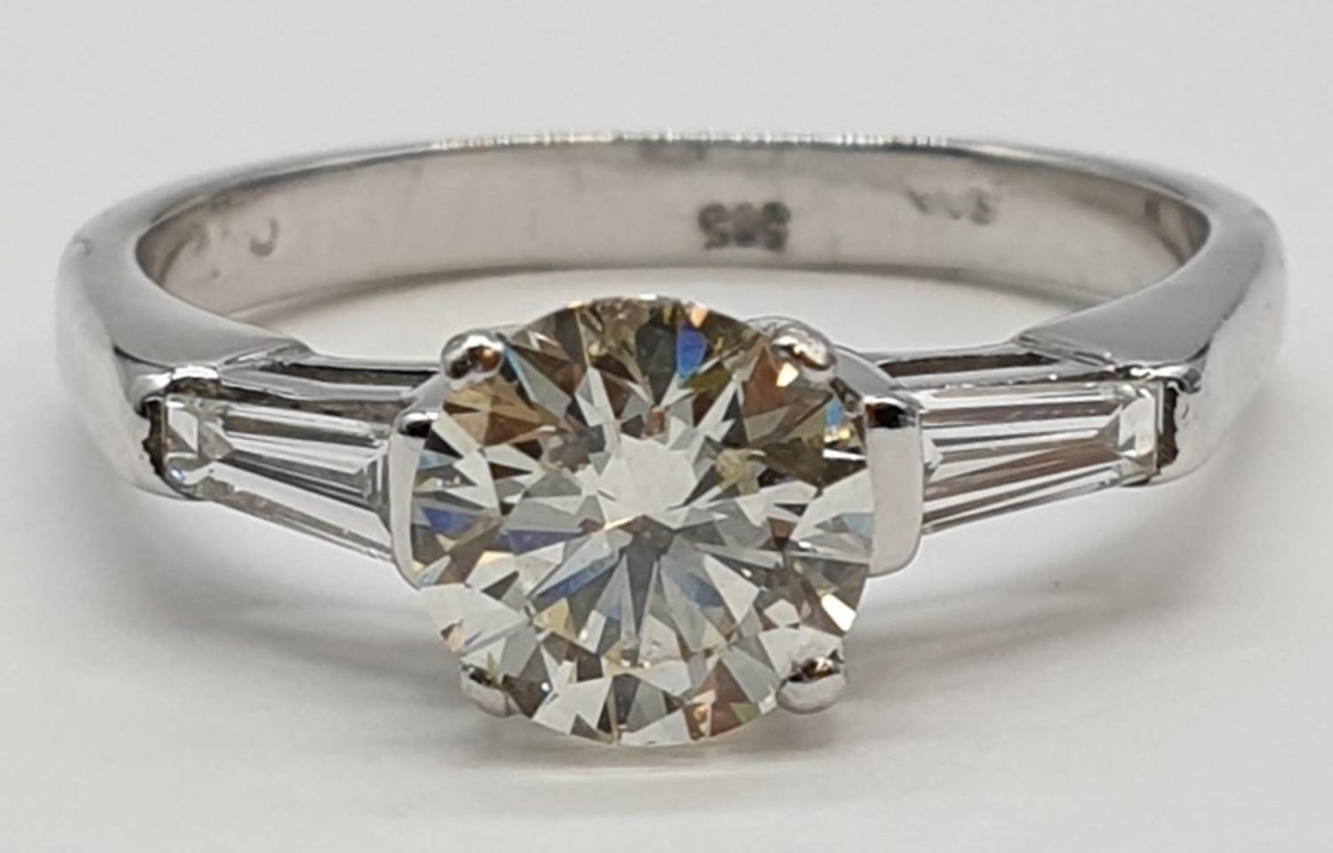 14ct white gold ring with 1.02ct diamond centre (colour J, clarity VS1) and 2 baguette cut