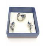 A ring and a matching pair of earrings in the shape of peacock feathers. In a presentation box. Ring