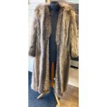 Longline Racoon fur jacket. Size small. Fully lined. Leather cuffs on sleeves.