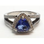 18CT WHITE GOLD RING WITH TRIANGULAR TANZANITE CENTRE AND DIAMONDS ON SHOULDERS, WEIGHT 7G AND