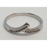 9ct White gold diamond set twist band ring. Weight 1.2g, Approx. 0.10ct of diamond, Size L.