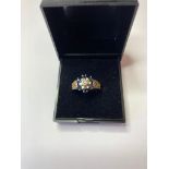 9ct Gold and Sapphire ring having six sapphires in a flower setting with illusion set diamond to