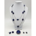 Suite of lapis lazuli jewellery set in 925 silver to include a 104cm long chain, a large brooch (