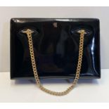 Vintage Gucci styled black patent handbag. Gold chain strap, unusual clasp on top. Interior zip