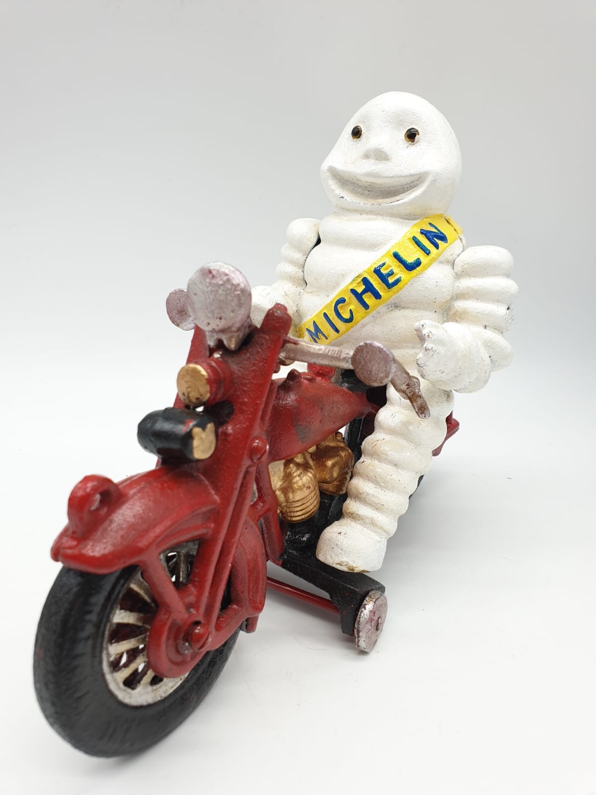 A collector?s item, French, cast iron, MITCHELIN MAN, on a motorbike. Wheels turning with special