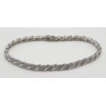 9ct white gold bracelet with 0.30ct diamonds. 20cm in length, weight 7 grams.