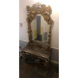 A Baroque-style marble hall mirror attached to a marble dress, decorated with gold gilt, cherubs and