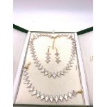 A highly unusual, white pearl necklace, bracelet and earrings set in a presentation box. Silver (