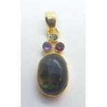 A cats eye pendant with peridot, garnet and amethyst. Weight 4.6g.
