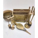A bronze selection of vintage fireside utensils including decorated brass bellows.