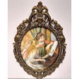An Italian Rococo styled frame encapsulating Renoir's 'Young girls at the piano'. 31cm wide.