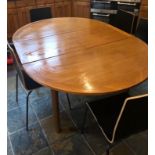 Extendable wooden dining table with eight black chairs. 4ft x 7ft
