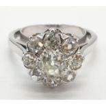 Platinum diamond cluster ring in floral design, weight 5.58g and size P with over 3ct diamonds