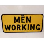 A vintage 'Men Working' metallic sign. Black print on yellow.