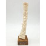 Carved bone sculpture of African Water-Bearer. Height 18cm.