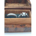 A pair of rings with cubic zirconia, presented in a beautiful wooden box. Ring size: N