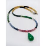 A single row ruby, emerald and sapphire necklace with emerald drop. 18.8 grams in weight. 44cm in