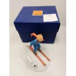 A Tin Tin Herge Moulinsart model of Tin Tin skiing with Snowy. Good condition with box and comes