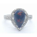 A 18ct white gold and diamond ring with black opal centre stone. Weight 3.6g, Size N.