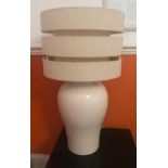 A pair of White bedside lamps with retro split-level lampshades. 66cm in height.