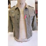 German M42 Field Blouse. Maybe a re-enactors jacket or movie prop with original insignia and wound