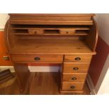 A solid pine wood roll top bureau with four deep drawers and a narrow draw underneath roll top. Good