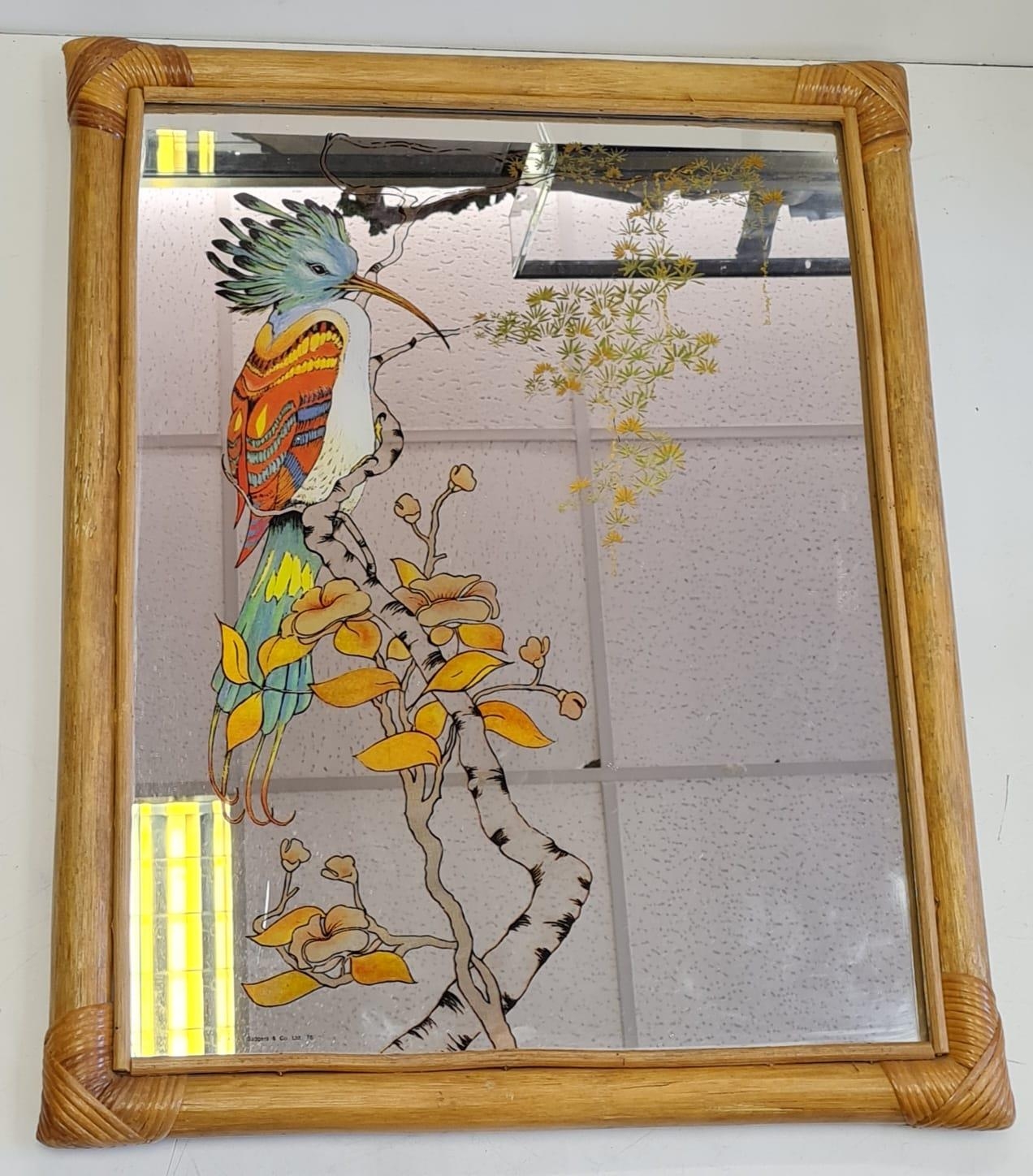 Large wood framed mirror incorporating a bird design.