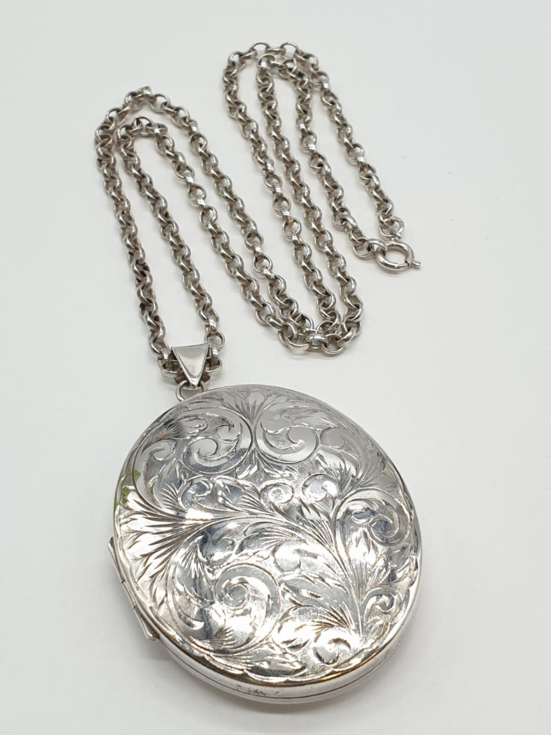 Vintage Large Silver Locket having scroll work to front. Mounted on a long silver belcher type