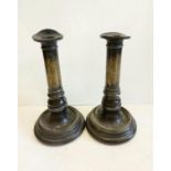 A pair of Victorian brass candlesticks, engraved with VR next to crown. 22cm high.