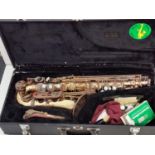 A brass saxophone - the signature series. Original case in good working condition but needs cosmetic