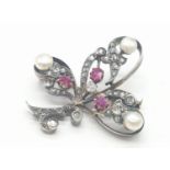 Aspreys diamond and ruby brooch embellished with pearls, weight 7.5g and 35mm long approx