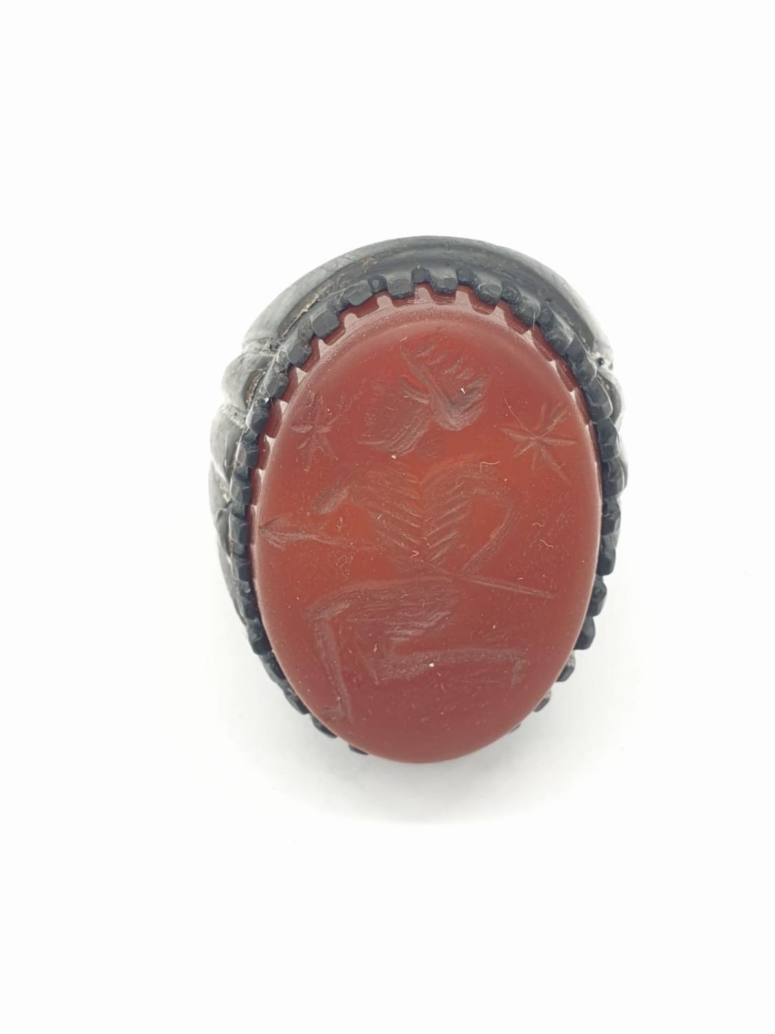 A Roman-Thracian silver ring with a carved carnelian seal depicting a soldier with a spear. The ring