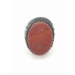 A Roman-Thracian silver ring with a carved carnelian seal depicting a soldier with a spear. The ring