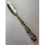 Antique silver butter knife, larger than usual and having scroll work to blade and handle. Excellent
