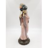 A Lladro porcelain figurine of a timid Japanese Geisha with fan. Very good condition. 30cm high.