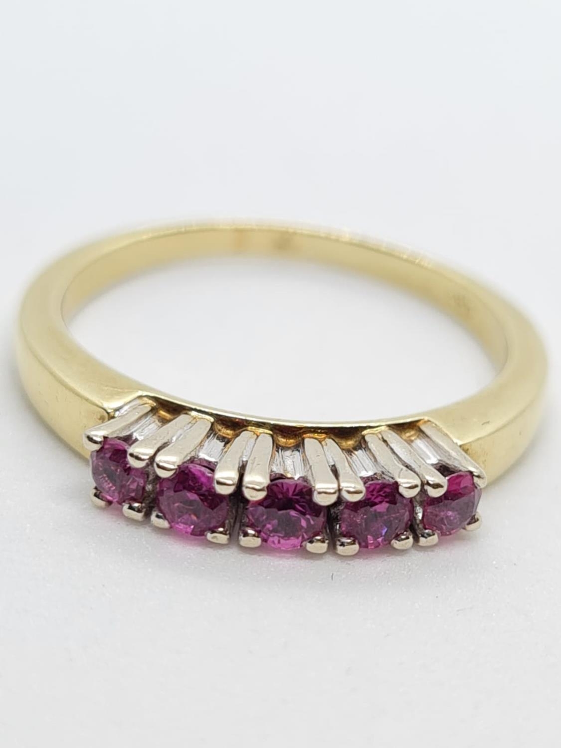 14ct yellow gold with 5 rubies. Size N. 3.3g in weight.