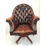 A vintage Chesterfield directors swivel office chair. Brown leather, deep buttoned and flanked by