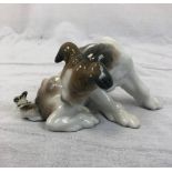 A Lladro porcelain figurine of a dog at play with a butterfly. Good condition. 17x9cm.