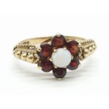Vintage 9ct gold garnet and Opal ring ,having Gold beads to shoulders. Full London Hallmark for