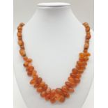 Interesting amber coloured necklace. 85.1g in weight. 52cm in length.