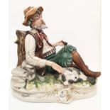 A Capodimonte figure of a resting hunter. 25cm tall, 26cm diameter.