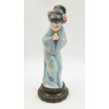 A Lladro Japanese porcelain figurine in a 'Sayonara' pose. 27cm high. Good condition.