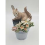 A Lladro porcelain figurine of a squirrel and a snail at play. Good condition. 10 x 14cm.