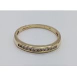 9CT YELLOW GOLD DIAMOND SET HALF ETERNITY RING WITH APPROX 0.18CT, WEIGHT 1.38G AND SIZE N