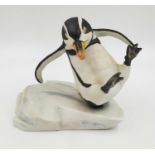 A hand painted porcelain figurine of a penguin slipping on ice. 'Whoops!' Good condition. 15x15cm.