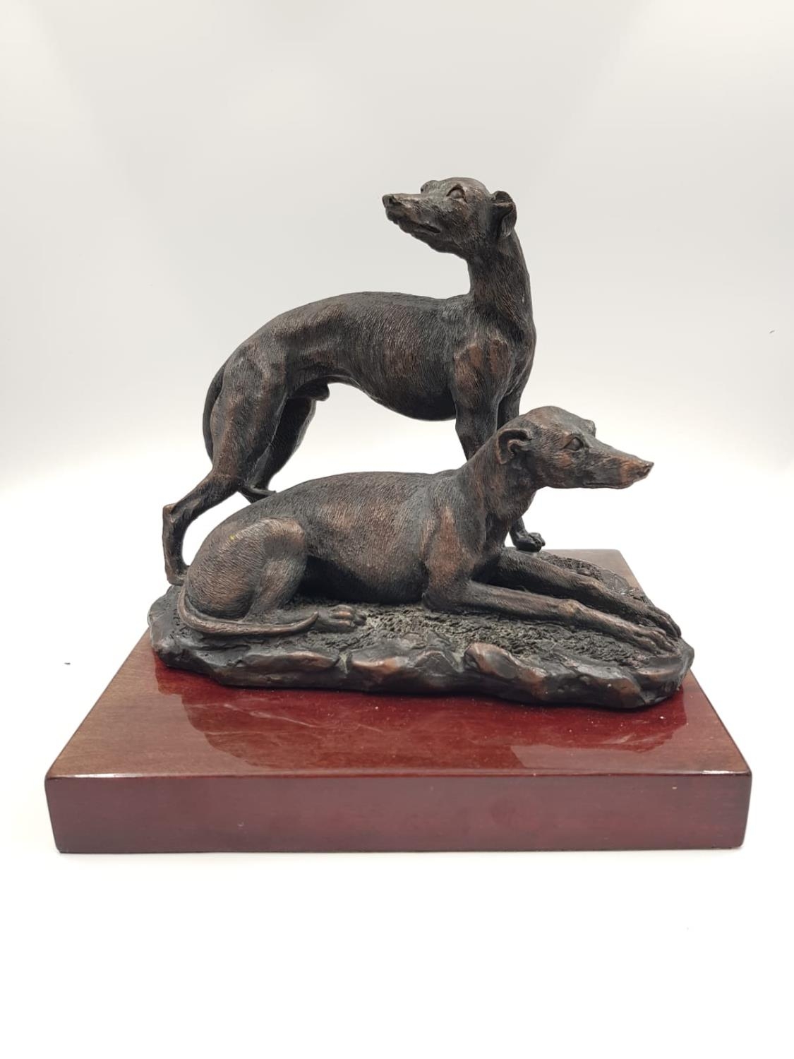 A 2003 signed brass sculpture by Posa - depicting two greyhounds. One at rest, the other alert.